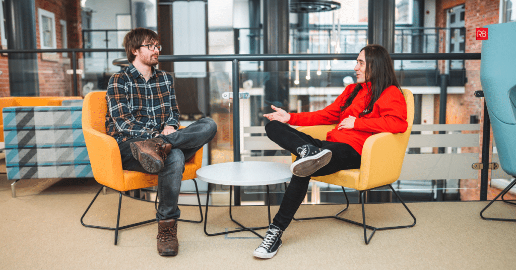 Two web designers discussing how to Win More RFQs, RFPs & Tenders with Your Website