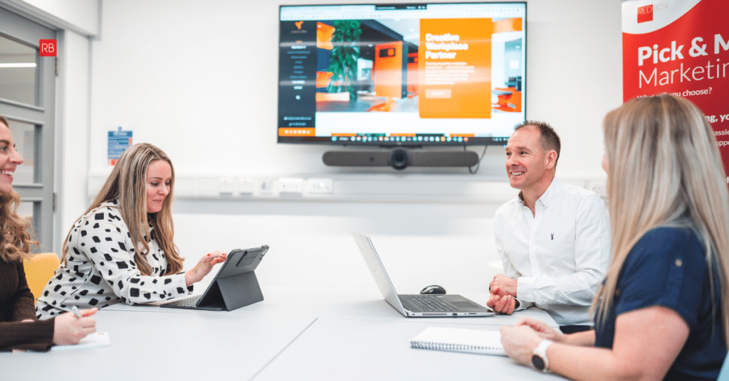 Two people discussing a project in a meeting, representing sales conversations and early stage planning before starting a project